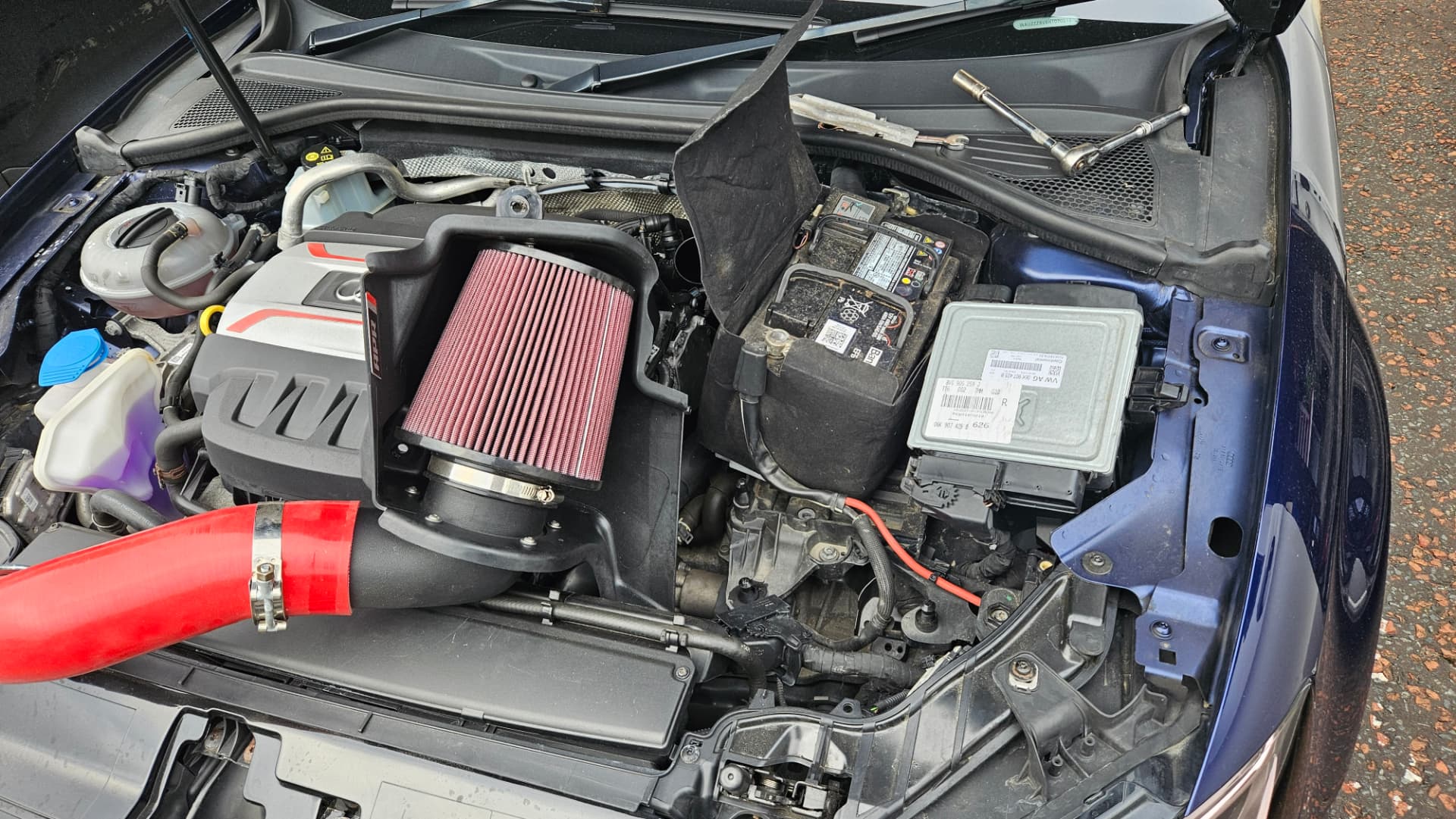 VW engine bay with induction kit and ECU removed for tuning